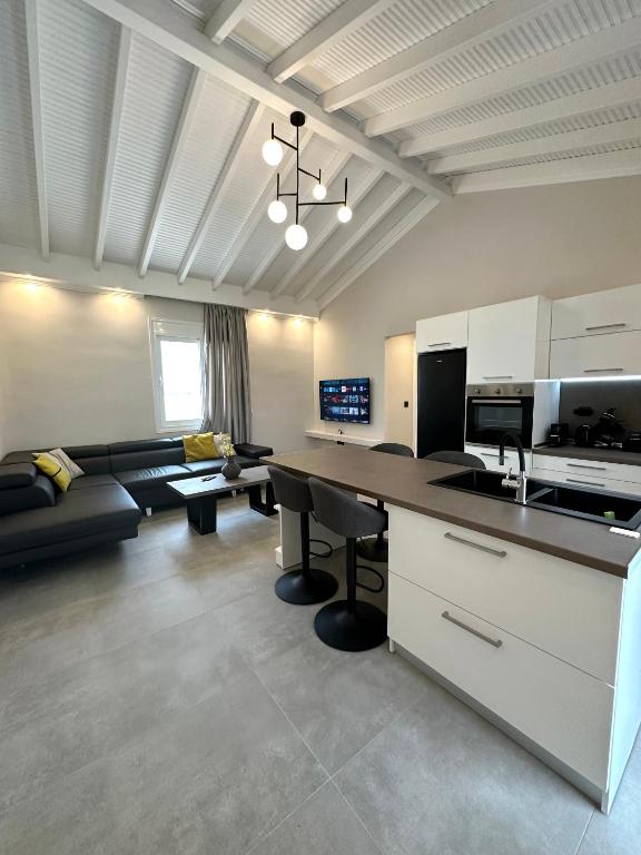 a large living room with a couch and a table at Theros 2 in Xanthi