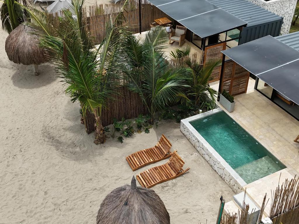an overhead view of a resort with chairs and a swimming pool at Luxury Suite frente de Mar Piscina Restaurante y Bar in San Silvestre