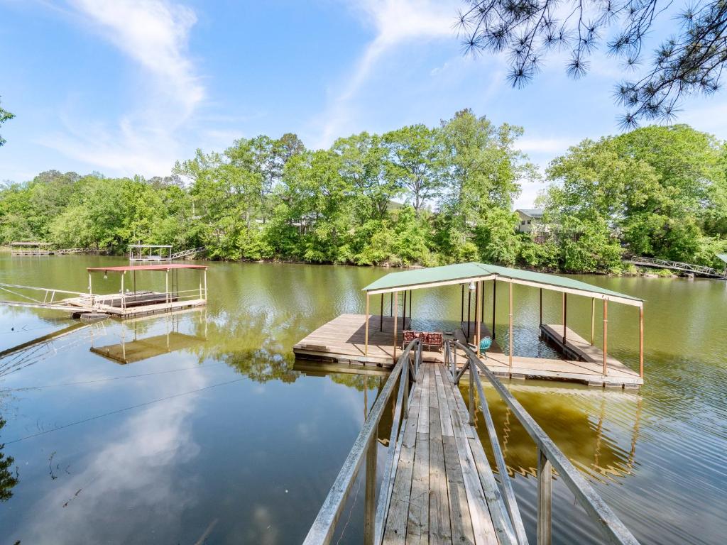 a dock on a lake with a building on it at Jax Joint - Pet Friendly - Perfect Family Vacation Spot! in Crane Hill