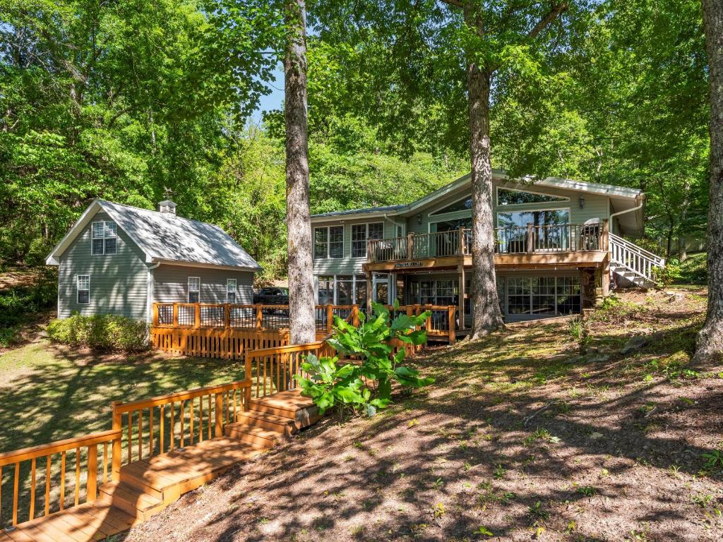 a house in the woods with a deck and trees at Sheltered Cove - Family-Friendly With Lots Of Options! in Jasper