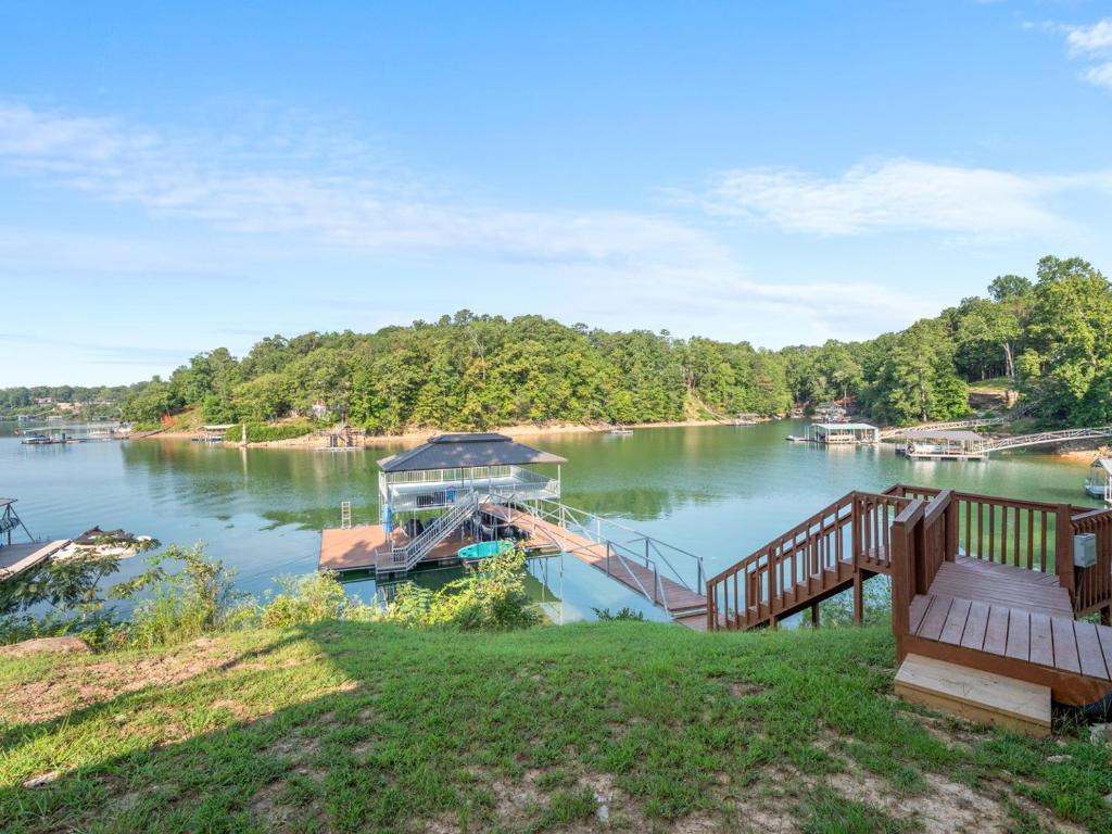 a dock with a boat on a lake at Sweet Retreat - Great Views Of The Lake! in Houston