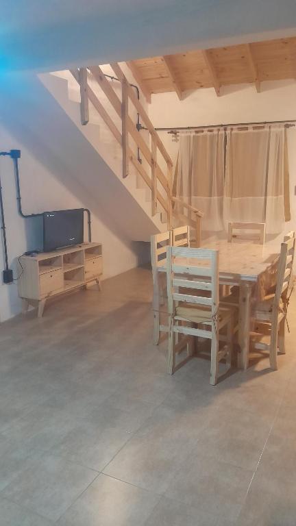 a dining room with a wooden table and chairs at Los Almendros in Nueva Atlantis
