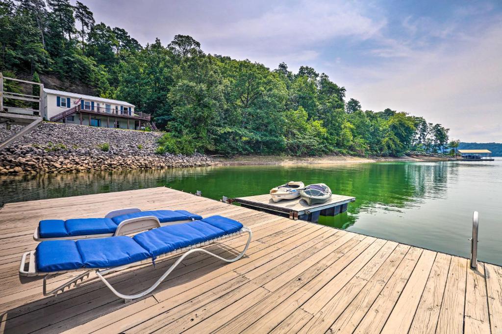 a raft with blue chairs on a dock on a lake at Cranes Nest - Huge Dock With Two Kayaks For The Guest's Use! in Crane Hill