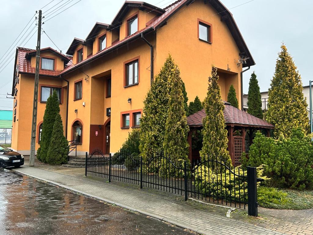 a large house with a fence in front of it at Zajazd Bachus in Dąbrowa Górnicza
