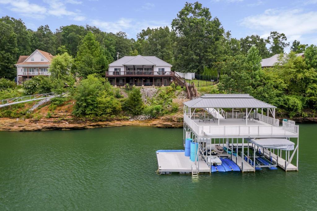 a dock in the middle of a lake with a house at Blessings Family Lodge- Amazing Sunsets, Amazing Views! in Houston