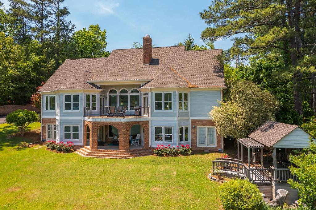 a large house with a large yard with grass at Lake Therapy - Gazebo On The Lake, Easy Walk To The Water! in Crane Hill
