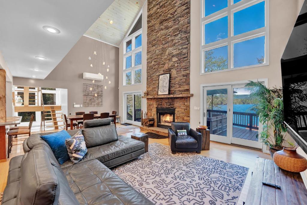 a living room with a couch and a fireplace at Lakefront Sunsets, Hot Tub, Pool Table, Kayaks in Lake Ariel