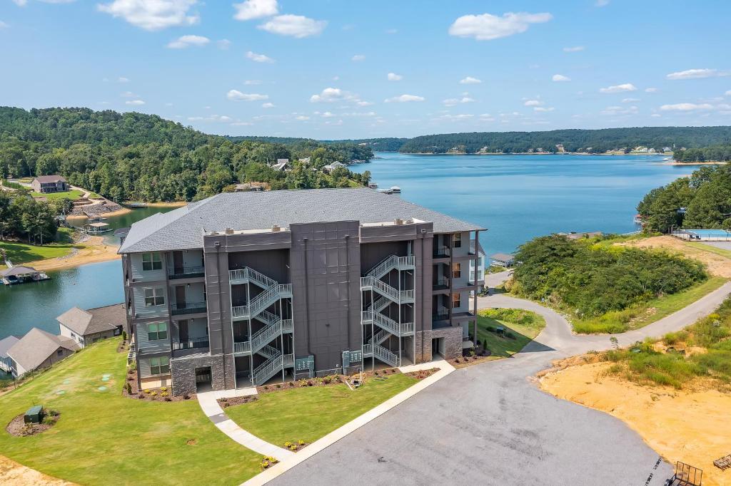an aerial view of a building next to a lake at Mallard Pointe Unit 200- Luxury Condo- Conveniently Located! in Cullman