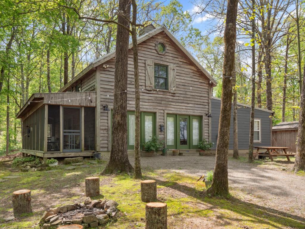 a wooden house in the woods with trees at Wonderland Cabin - Quiet, Family-Friendly Stay - Near The Barn in Bremen