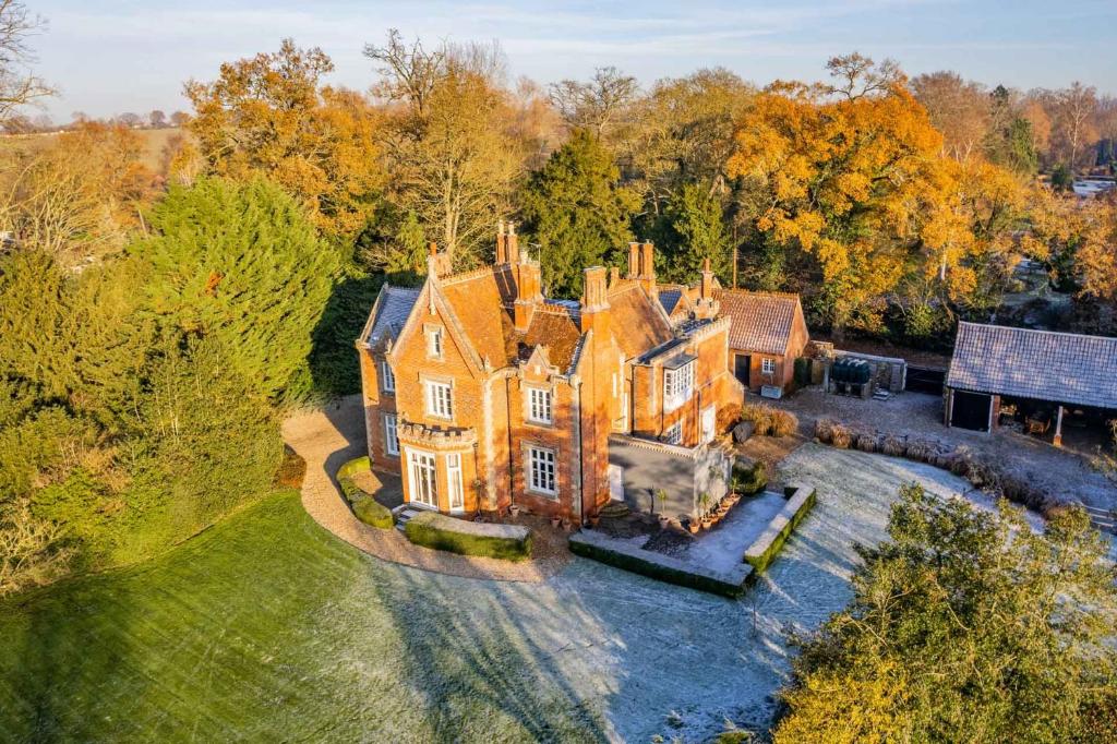 an aerial view of a large house with trees at Bressingham Lodge by Leap Escapes in Diss