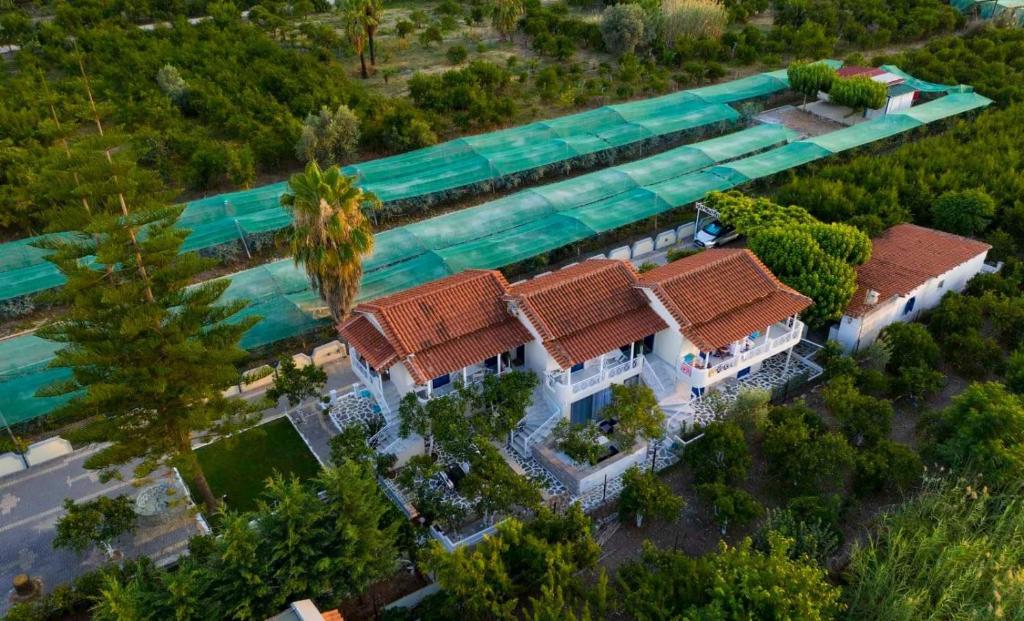 an overhead view of a house with a swimming pool at arome de grenade in Nea Epidavros