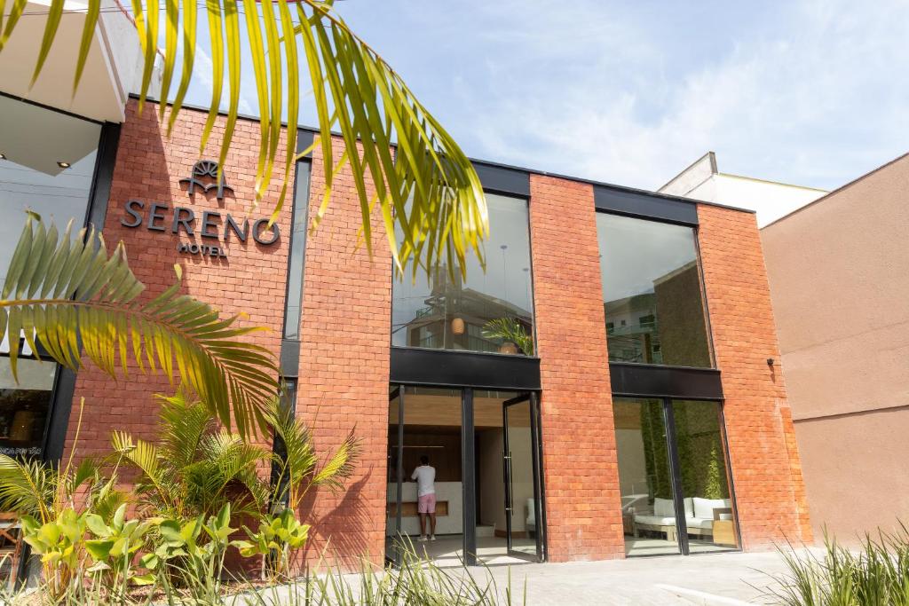 a red brick building with a sign on it at Sereno Hotel in Cabo Frio