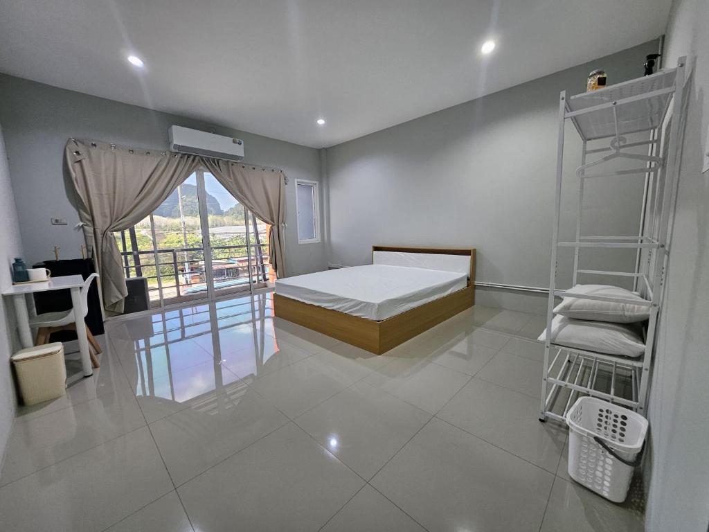a room with a bed and a ladder in it at Safary Tour in Ban Ta Kun