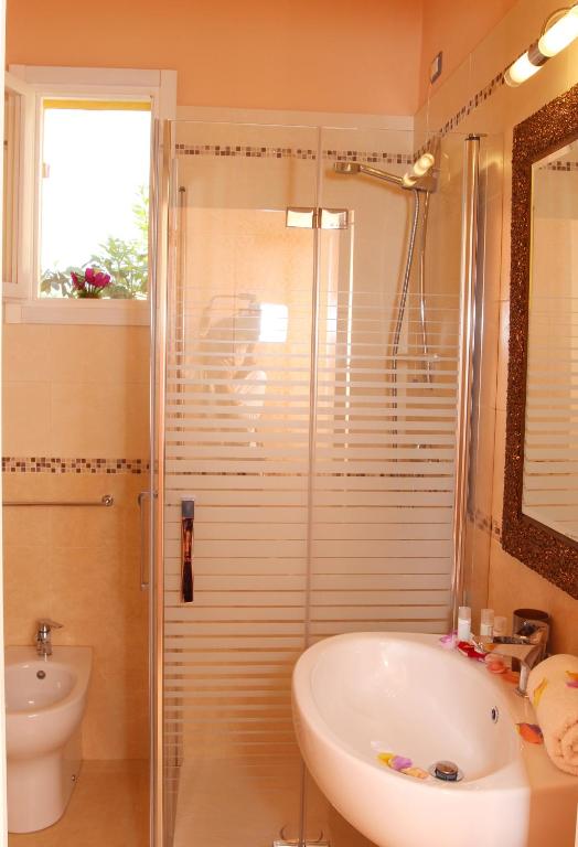 a bathroom with a shower and a tub and a sink at Tenuta Paifer in Otranto