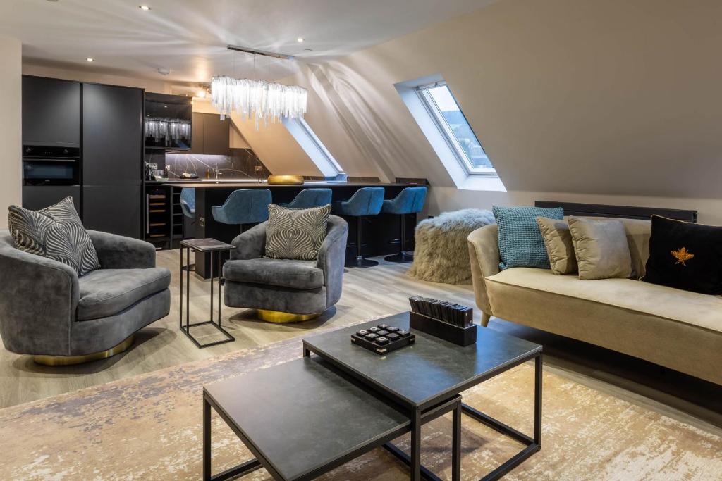 a living room with couches and a bar at Arran Shores Luxury Shorefront Penthouse Suite 13 in Lamlash