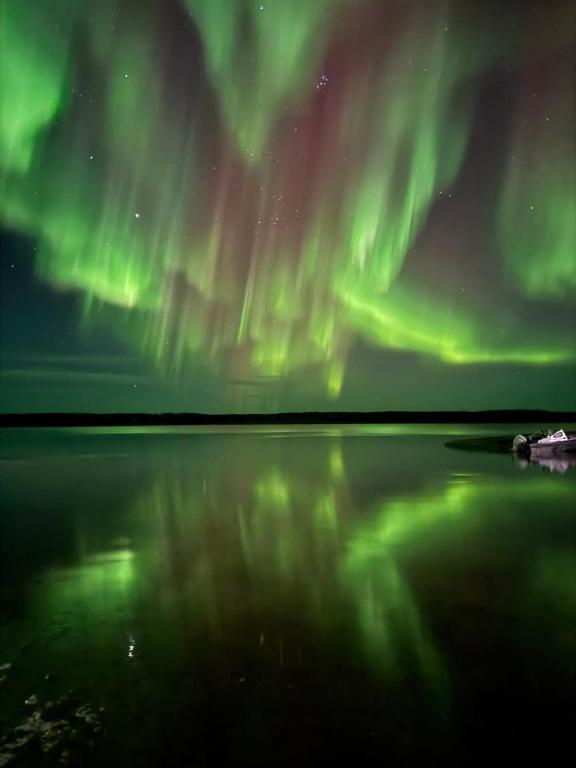 a view of the aurora over a body of water at Aurora views from 2 br apartment by lake in Yellowknife