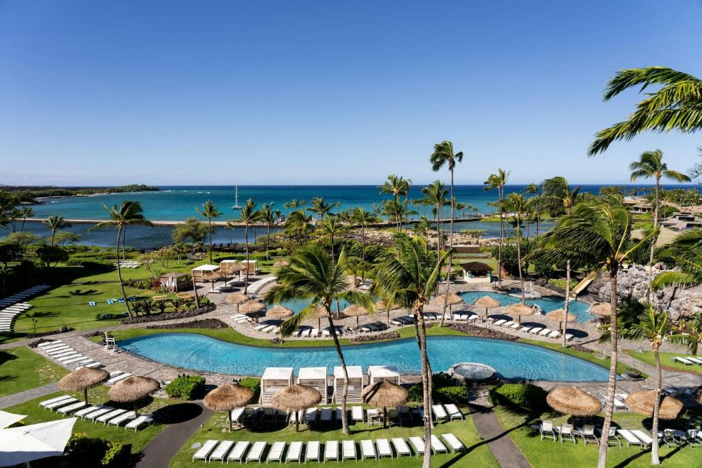 an aerial view of a resort with a pool and the ocean at Waikoloa Beach Marriott Resort & Spa in Waikoloa
