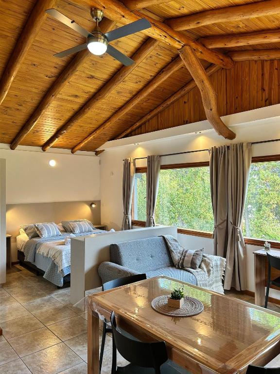 a living room with a bed and a table at Luminosa Patagónia in Lago Puelo