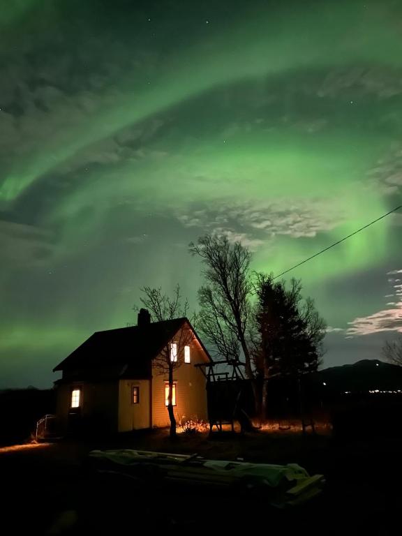 a house with a rainbow in the sky at night at Old farm house & sauna in Stunes