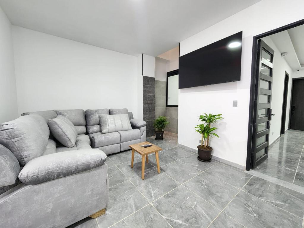 a living room with a couch and a flat screen tv at Apartamentos Batara in Filandia