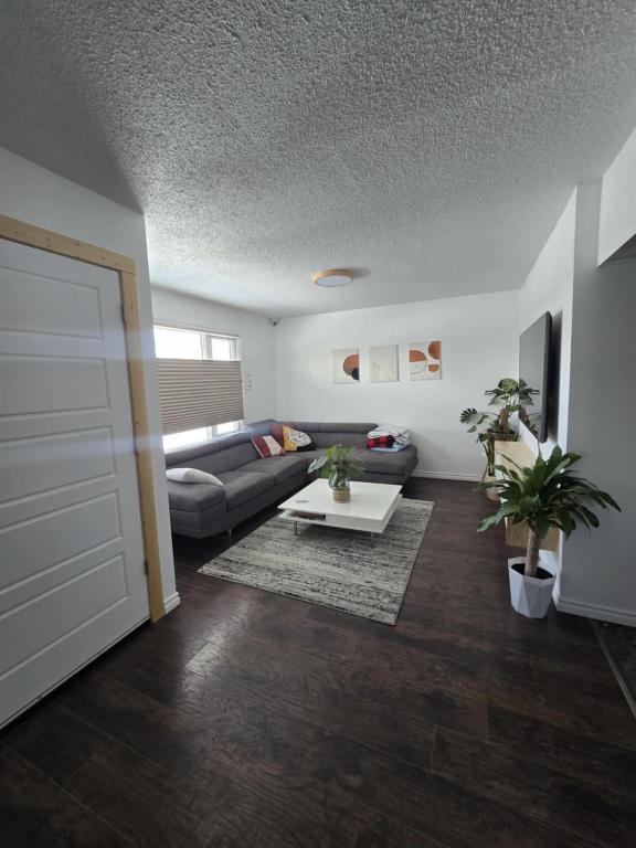 a living room with a couch and a table at Like Home in Regina