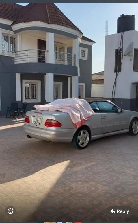 a car parked in a parking lot in front of a house at BUSUMBALA RESIDENTs in Busumbala
