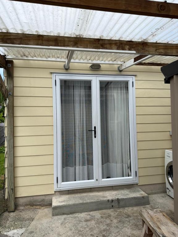 a sliding glass door on the side of a house at Lilys guest house in Auckland