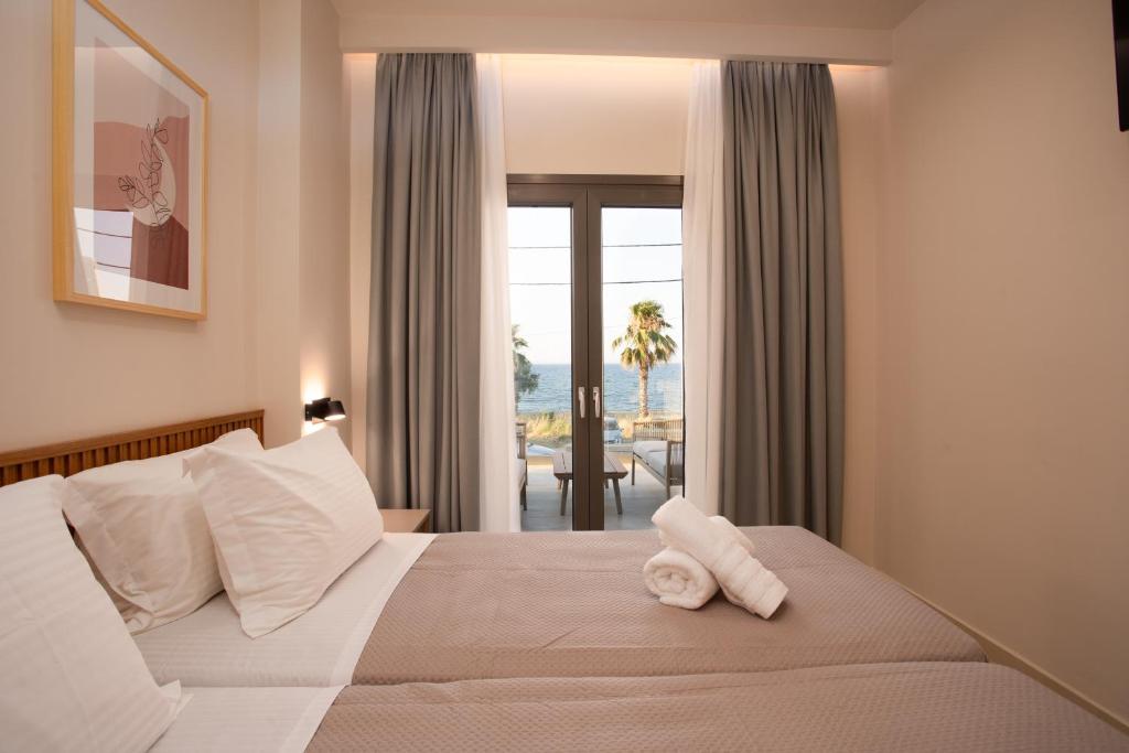 a hotel room with a bed with towels on it at Akti Vigla Premium in Mytilene