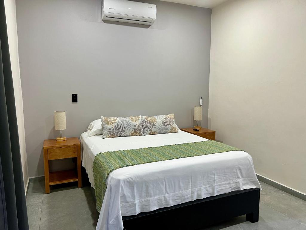 a bedroom with a bed and a air conditioner at Departamento la estación Tequila in Tequila