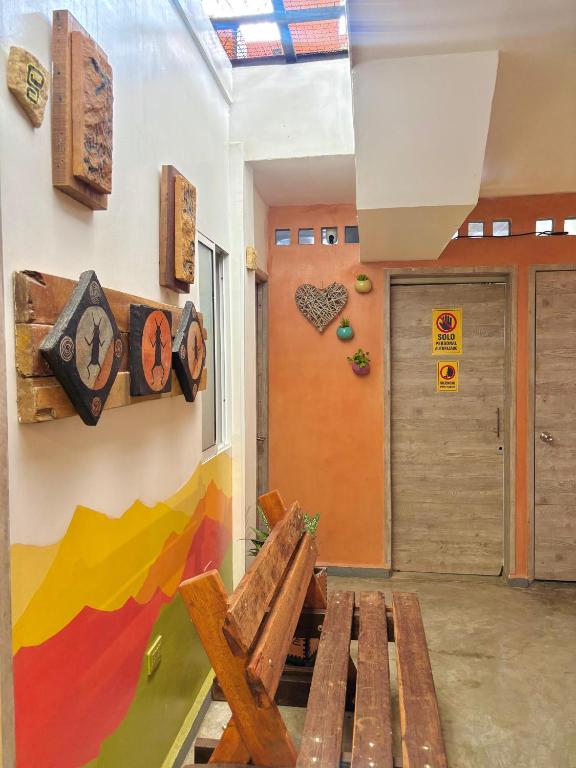 a room with a wooden bench and a door at Hotel Anauco in Bucaramanga