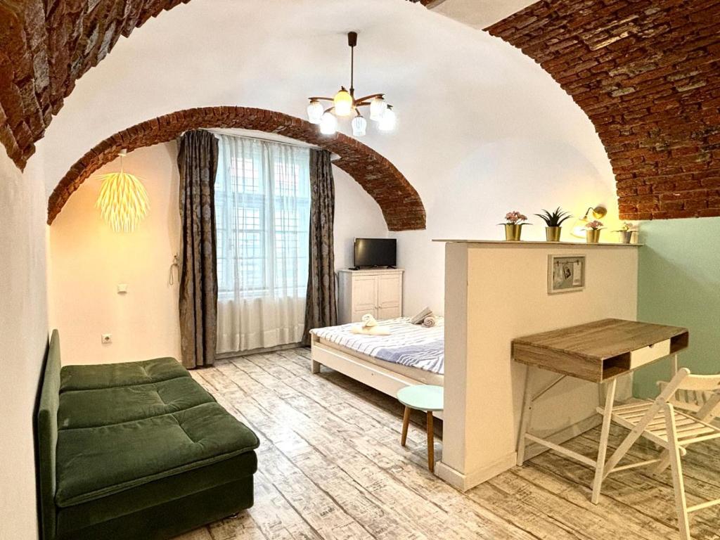a bedroom with a bed and a desk in a room at Roxen Central Studio Sibiu in Sibiu