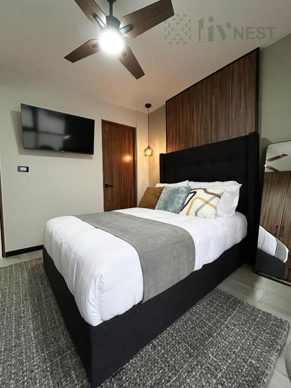a bedroom with a large bed with a ceiling fan at Private Suite with bathroom and top amenities in La Cañada