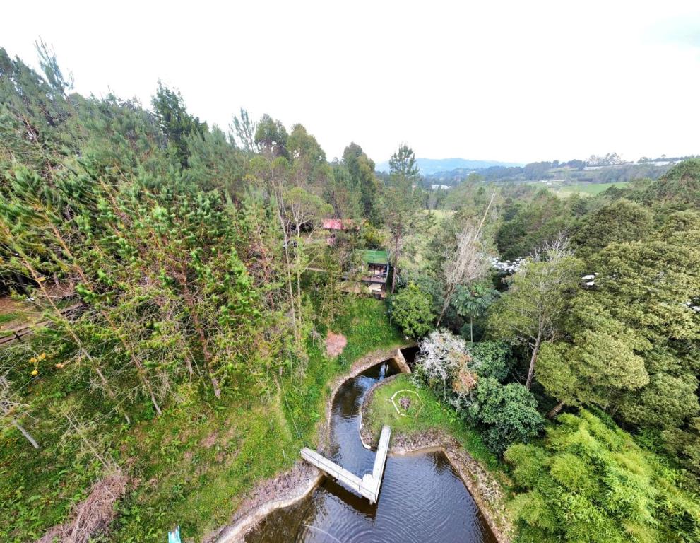an aerial view of a bridge over a river at Cabaña en el Lago Cerca MetroCable ARVI in Guarne