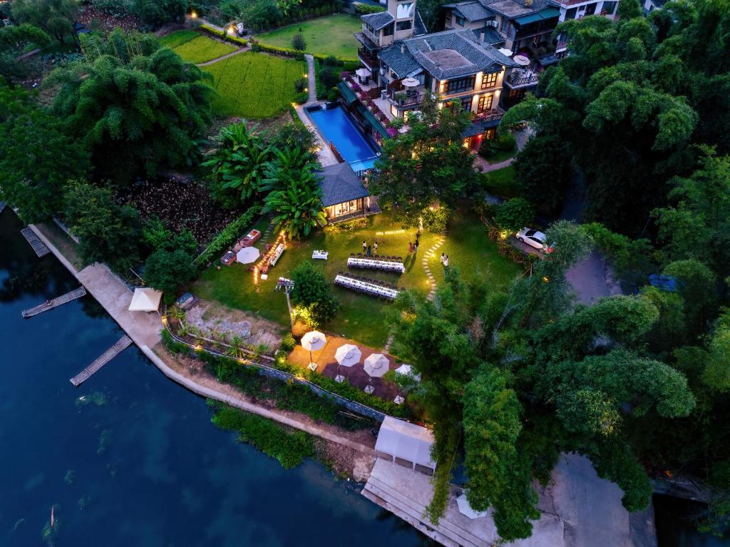 an aerial view of a house on an island in the water at Moondance Boutique Resort in Yangshuo
