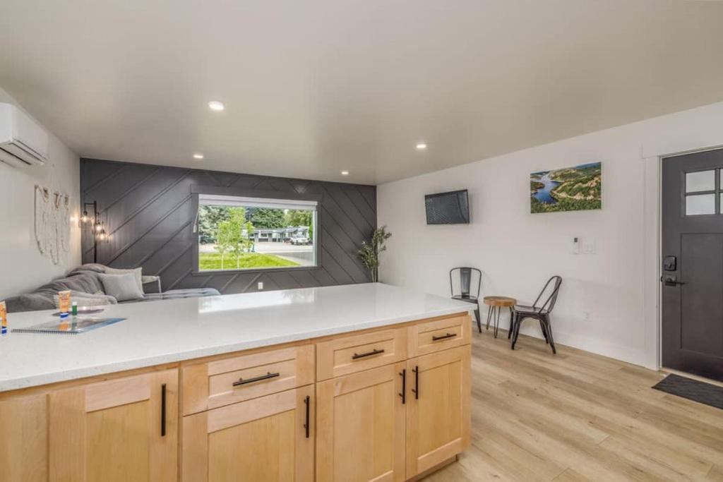 a kitchen with a white counter top and a table at The Flats- Executive Suite-Downtown CDA in Coeur d'Alene