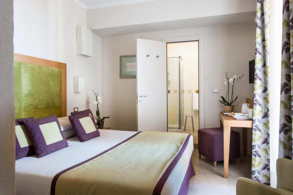 Postel nebo postele na pokoji v ubytování Hotel Perseo