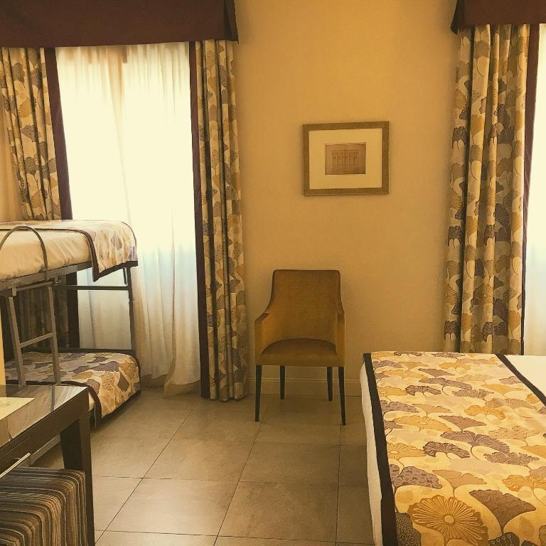 Postel nebo postele na pokoji v ubytování Hotel Perseo