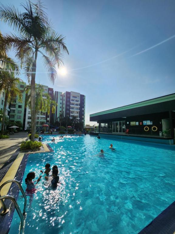 a group of people swimming in a swimming pool at Manhattan Condominium Ipoh in Ipoh