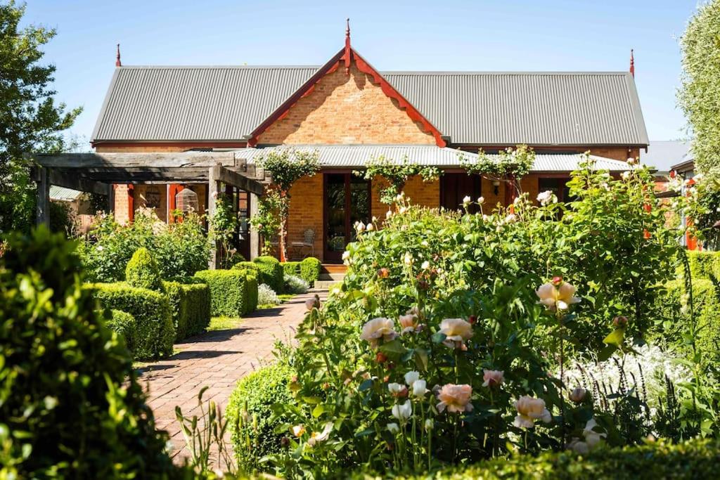 a house with a garden with flowers in front of it at Miss Martinellis in Beechworth