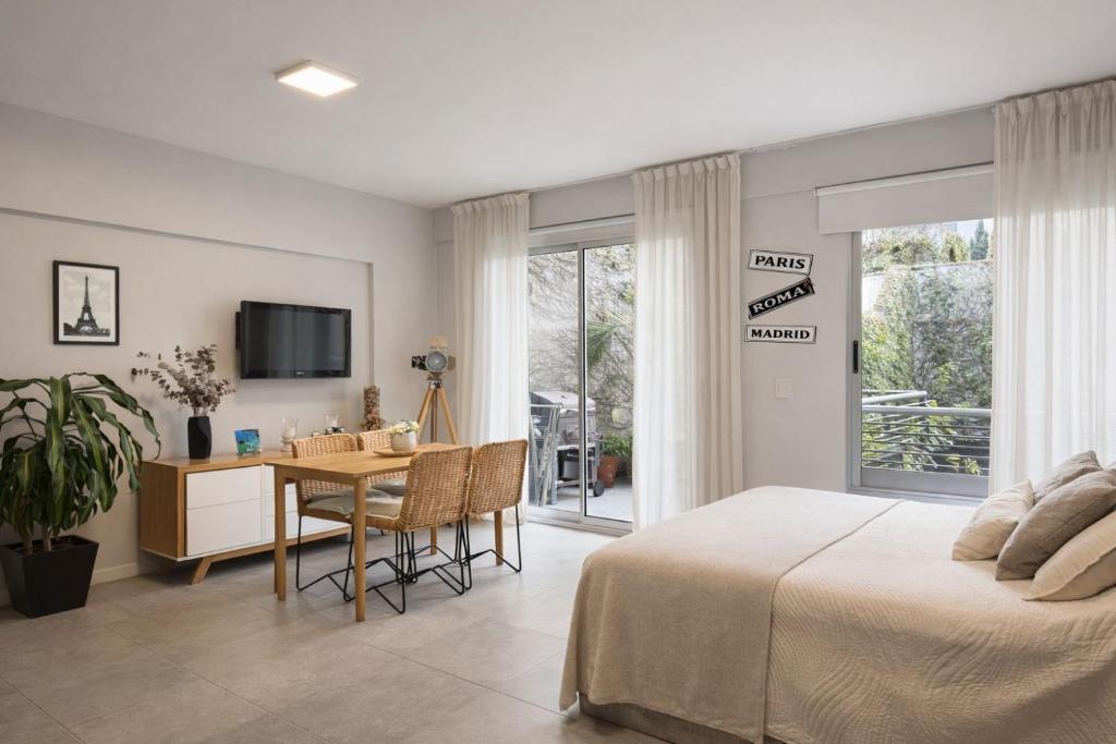 a bedroom with a bed and a table with a desk at CONFORT BELGRANO in Buenos Aires