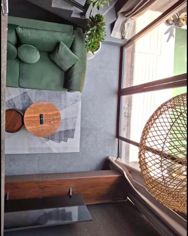 a living room with a window and a bench at Wolu Designer Loft - Private Pool & Tropical Garden, Canggu in Tumbak Bayuh