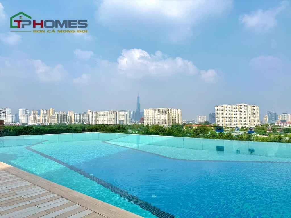 a large swimming pool with a view of the city at TPHomes 12 - The Sun Avenue in Ho Chi Minh City