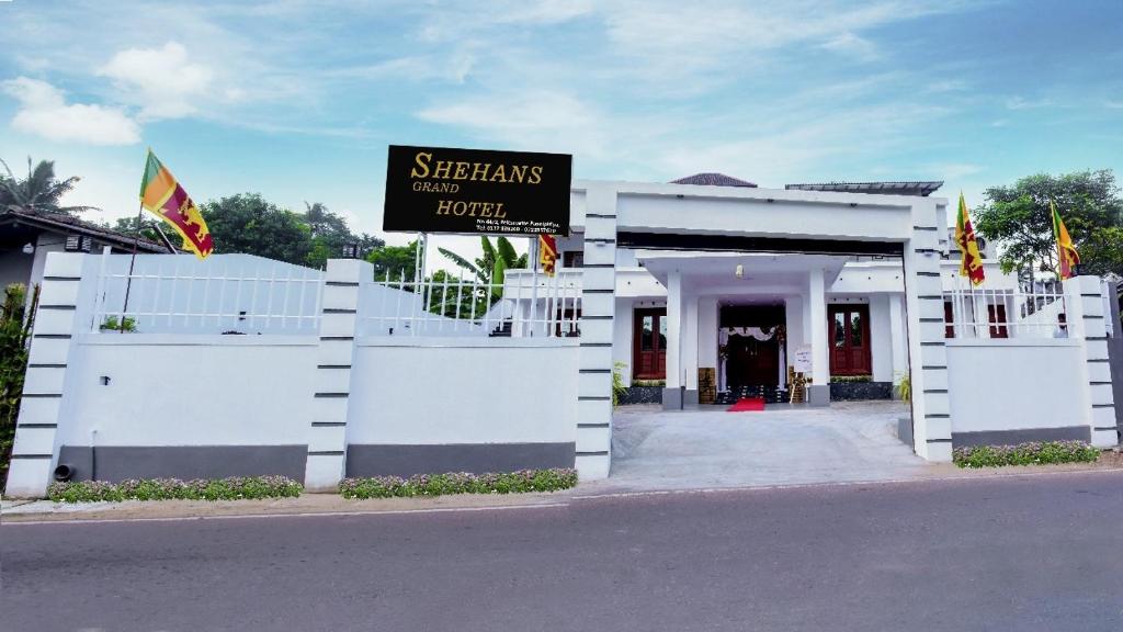 a white building with a sign in front of it at Shehan's Hotel Maharagama in Maharagama