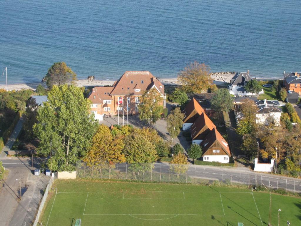 an aerial view of a house by the water at Danhostel Helsingør in Helsingør