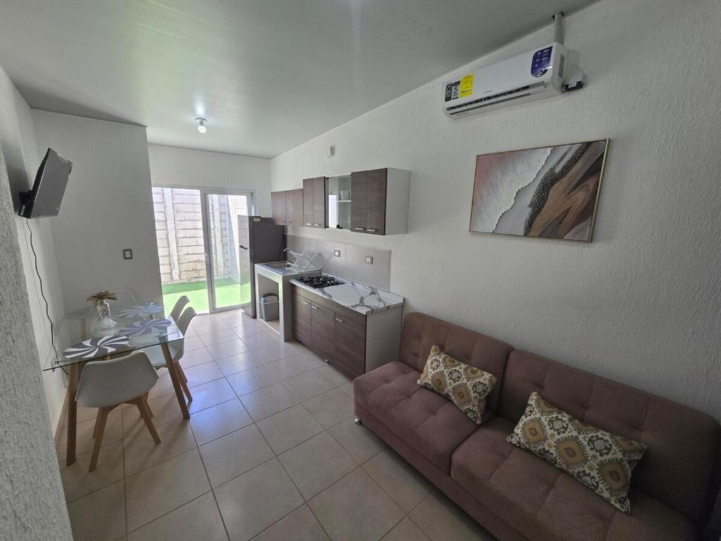 a living room with a couch and a table at Candy House Marsella in Sitio Grande