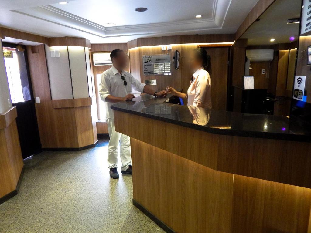 a man and a woman standing at a counter at Love Story (Adult Only) in Salvador