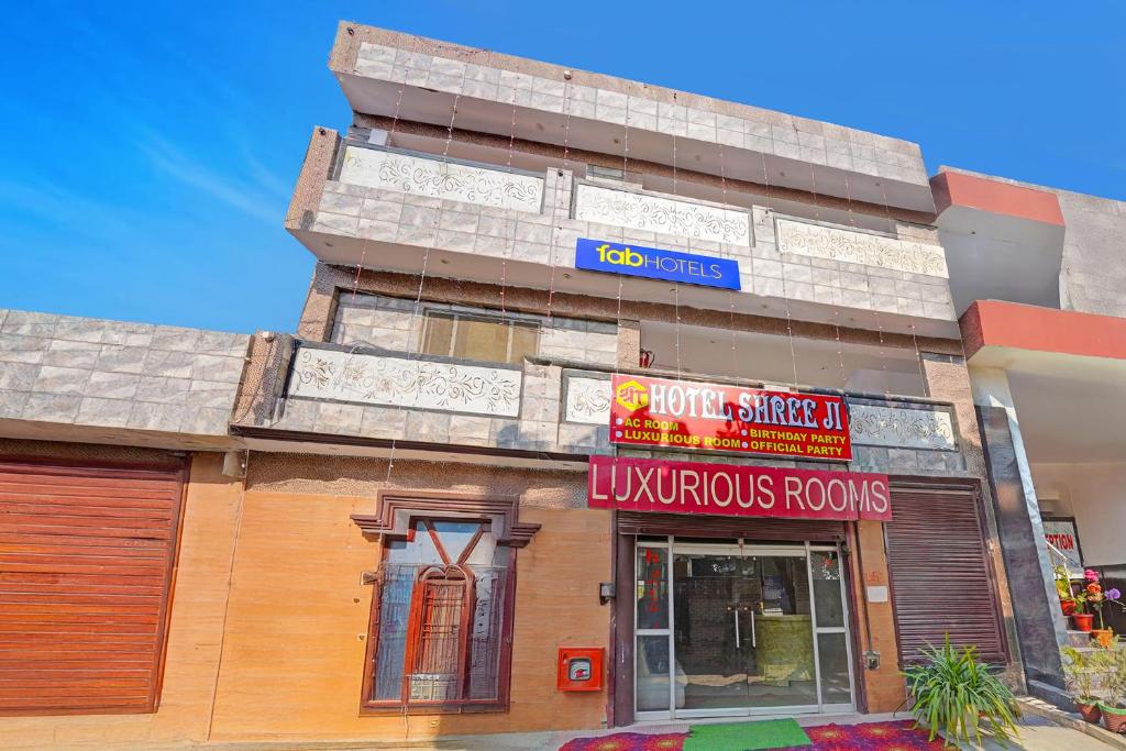 a building with a sign on the side of it at FabHotel Shree Ji in Lucknow
