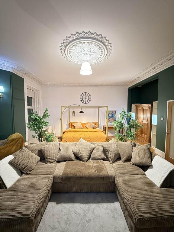 a large couch in a living room with a bed at Autumn’s Retreat in Newcastle upon Tyne