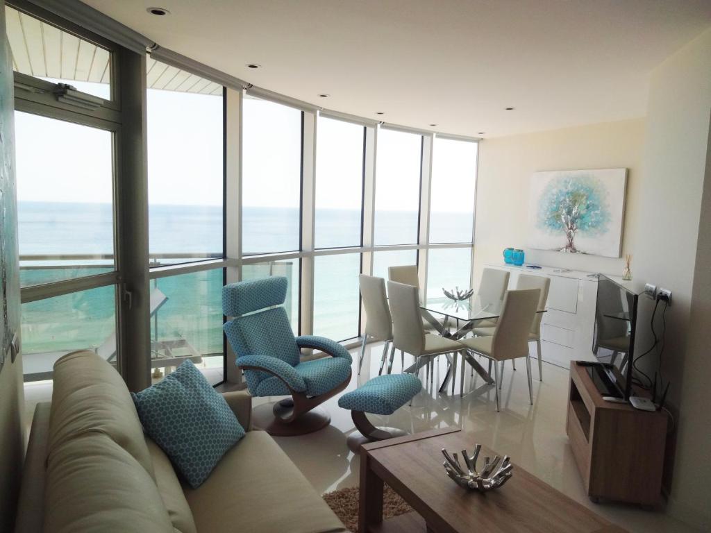 a living room with a couch and chairs and a table at Vista Bella Apartment in Calpe