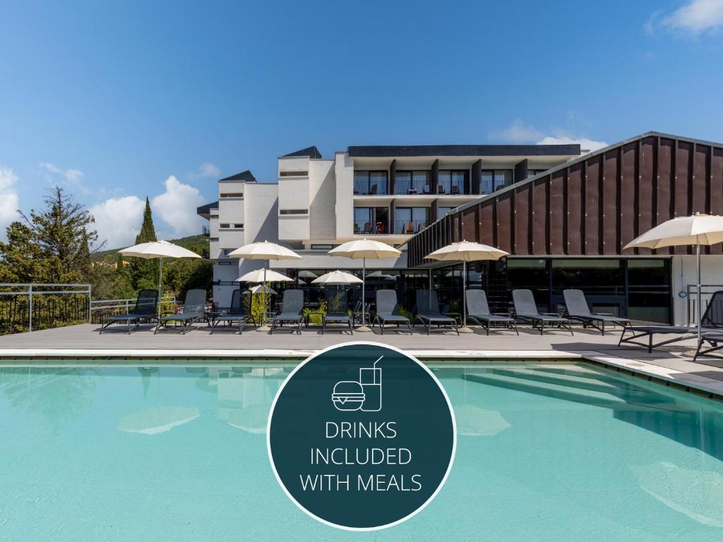 a swimming pool with a sign in front of a building at Hotel Ad Turres in Crikvenica